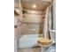 Bathroom with tiled tub and shower, grab bar, tile floor, and built-in shelves at 4300 Thom Blvd, Las Vegas, NV 89130