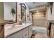 Bathroom with double sinks, framed mirrors, tile flooring, and tub with tiled shower and shelving at 4300 Thom Blvd, Las Vegas, NV 89130
