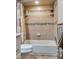 Bathroom featuring neutral tiling, built-in shelves, tub, shower, and tiled floors at 4300 Thom Blvd, Las Vegas, NV 89130