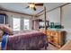Bedroom featuring a four-poster bed, tile floors, and a view of the outdoors at 4300 Thom Blvd, Las Vegas, NV 89130