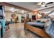 Open bedroom with tile floor, ceiling fans, natural wood furniture, and sitting area at 4300 Thom Blvd, Las Vegas, NV 89130