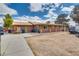 Side view of home with a long concrete parking area and desert landscaping at 4300 Thom Blvd, Las Vegas, NV 89130
