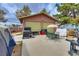 View of the back of the house with a two car garage, patio furniture and a tent at 4300 Thom Blvd, Las Vegas, NV 89130