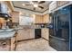 Traditional kitchen with black appliances, granite counters, and light wood cabinetry at 4300 Thom Blvd, Las Vegas, NV 89130