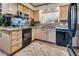 Traditional kitchen with black appliances, granite counters, and light wood cabinetry at 4300 Thom Blvd, Las Vegas, NV 89130