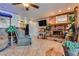 Inviting living room featuring a brick fireplace and views of kitchen and entry at 4300 Thom Blvd, Las Vegas, NV 89130