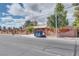 Front of home with a brick fence, a gate and well-maintained trees at 4300 Thom Blvd, Las Vegas, NV 89130