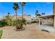 Well-maintained backyard with desert landscaping, gravel, mature trees and patio at 4431 Palm Mesa Dr, Las Vegas, NV 89120