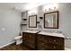 Elegant bathroom with dual sinks, dark wood cabinets, and modern light fixtures provides a spa-like experience at 4431 Palm Mesa Dr, Las Vegas, NV 89120