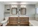 Bathroom features a double sink vanity with dark wood cabinets and a bathtub with decorative tile surround at 4431 Palm Mesa Dr, Las Vegas, NV 89120