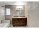 Bathroom with vanity, granite counters, decorative tile backsplash, shower and tub combination and modern fixtures at 4431 Palm Mesa Dr, Las Vegas, NV 89120