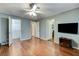 Bedroom featuring wood laminate floors, a TV, and multiple doors at 4431 Palm Mesa Dr, Las Vegas, NV 89120