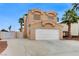 Two-story home featuring a two-car garage, tile roof and desert landscaping at 4431 Palm Mesa Dr, Las Vegas, NV 89120