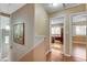 Upstairs hallway with art and views of bedrooms at 4431 Palm Mesa Dr, Las Vegas, NV 89120