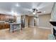 Open kitchen area with island, granite countertops, stainless steel appliances, and views of the living room at 4431 Palm Mesa Dr, Las Vegas, NV 89120
