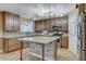 Bright kitchen featuring stone counters, an island, and stainless steel appliances at 4431 Palm Mesa Dr, Las Vegas, NV 89120