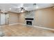 Living room featuring a cozy stone fireplace, ceiling fan, and tile flooring throughout at 4431 Palm Mesa Dr, Las Vegas, NV 89120