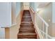 Staircase leading upstairs with wood stairs and white railing at 4431 Palm Mesa Dr, Las Vegas, NV 89120