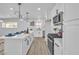 Close-up of an island in a modern kitchen, featuring barstools and modern appliances at 4500 Charles Ronald Ave, Las Vegas, NV 89121