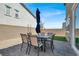 Outdoor patio with a dining set, complemented by a small grassy area and gravel landscaping at 4588 Swimming Minnow Ave, Las Vegas, NV 89141