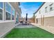 Large backyard with stone patio, dining set, grass area, and gravel landscaping at 4588 Swimming Minnow Ave, Las Vegas, NV 89141