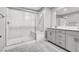 Modern bathroom featuring a glass enclosed shower, tile floors, and a double sink vanity at 4588 Swimming Minnow Ave, Las Vegas, NV 89141