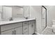 Modern bathroom features dual sinks with white countertops, and a glass-enclosed shower at 4588 Swimming Minnow Ave, Las Vegas, NV 89141