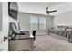 Comfortable bedroom includes a desk, daybed, ceiling fan, and ample natural light at 4588 Swimming Minnow Ave, Las Vegas, NV 89141