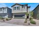 Charming two-story home showcasing a neutral color scheme, two-car garage, and a well-maintained landscaped yard at 4588 Swimming Minnow Ave, Las Vegas, NV 89141