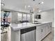 Open floor plan featuring kitchen with a center island and stainless steel dishwasher at 4588 Swimming Minnow Ave, Las Vegas, NV 89141