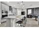 Modern kitchen features a large island with bar seating, pendant lights, and stainless steel appliances at 4588 Swimming Minnow Ave, Las Vegas, NV 89141