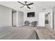 Spacious bedroom with two chairs, TV, ceiling fan and neutral tones at 4588 Swimming Minnow Ave, Las Vegas, NV 89141