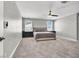 The main bedroom has a king-size bed, a ceiling fan and large windows at 4588 Swimming Minnow Ave, Las Vegas, NV 89141