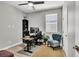 Home office with wood-look flooring, ceiling fan, and ample natural light at 4588 Swimming Minnow Ave, Las Vegas, NV 89141