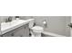 Powder room with a stylish vanity, modern fixtures, and a toilet at 4588 Swimming Minnow Ave, Las Vegas, NV 89141