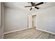 This bedroom has new gray floors, ceiling fan, and a door that leads to the ensuite bathroom at 5121 Pioneer Ave # 204, Las Vegas, NV 89146