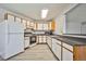Bright kitchen featuring white cabinets, laminate countertops and light wood grain flooring at 5121 Pioneer Ave # 204, Las Vegas, NV 89146