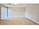 The bright living room has gray floors and sliding glass doors that lead to the patio at 5121 Pioneer Ave # 204, Las Vegas, NV 89146