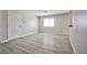 Open-concept living room with neutral walls and light-colored wood grain flooring at 5121 Pioneer Ave # 204, Las Vegas, NV 89146