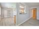 Bright living room featuring updated gray flooring, sliding glass door and breakfast bar through to the kitchen at 5121 Pioneer Ave # 204, Las Vegas, NV 89146