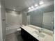 Well-lit bathroom featuring dark cabinetry, ample counter space, and a shower-tub combination at 5180 Hisopo St # Lot 24, Las Vegas, NV 89122