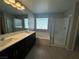 Modern bathroom features a double vanity, soaking tub, and glass-enclosed shower at 5180 Hisopo St # Lot 24, Las Vegas, NV 89122