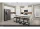 Modern kitchen featuring white cabinets, stainless steel appliances, and a center island with bar seating at 5180 Hisopo St # Lot 24, Las Vegas, NV 89122