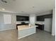 Modern kitchen with dark cabinets, light countertops, a center island, and stainless steel appliances at 5180 Hisopo St # Lot 24, Las Vegas, NV 89122