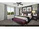 Beautiful main bedroom with a decorative accent wall, large windows and furnishings at 5180 Hisopo St # Lot 24, Las Vegas, NV 89122