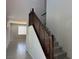 Carpeted staircase with dark wood railing leading to the upper level, with bright neutral walls at 5180 Hisopo St # Lot 24, Las Vegas, NV 89122