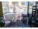 This balcony is furnished with chairs and a decorative rug, offering a cozy outdoor space at 5206 Mandalay Springs Dr # 204, Las Vegas, NV 89120