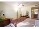 This bedroom features a ceiling fan, decorative accents, and an ensuite bathroom entrance at 5206 Mandalay Springs Dr # 204, Las Vegas, NV 89120
