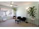 Relaxing bedroom with large window, leafy houseplants, and neutral carpet flooring at 5206 Mandalay Springs Dr # 204, Las Vegas, NV 89120