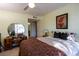 Tranquil bedroom featuring a unique vanity, a comfortable bed, and a decorative painting at 5206 Mandalay Springs Dr # 204, Las Vegas, NV 89120